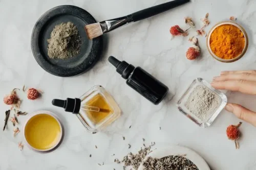 Assorted skincare ingredients and oils on a marble surface - Waterless Skincare: Benefits, Products & Sustainability - Zicail