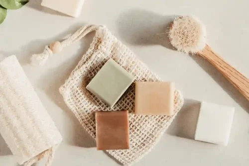 Solid soap bars with exfoliating tools on a neutral surface - Waterless Skincare: Benefits, Products & Sustainability - Zicail