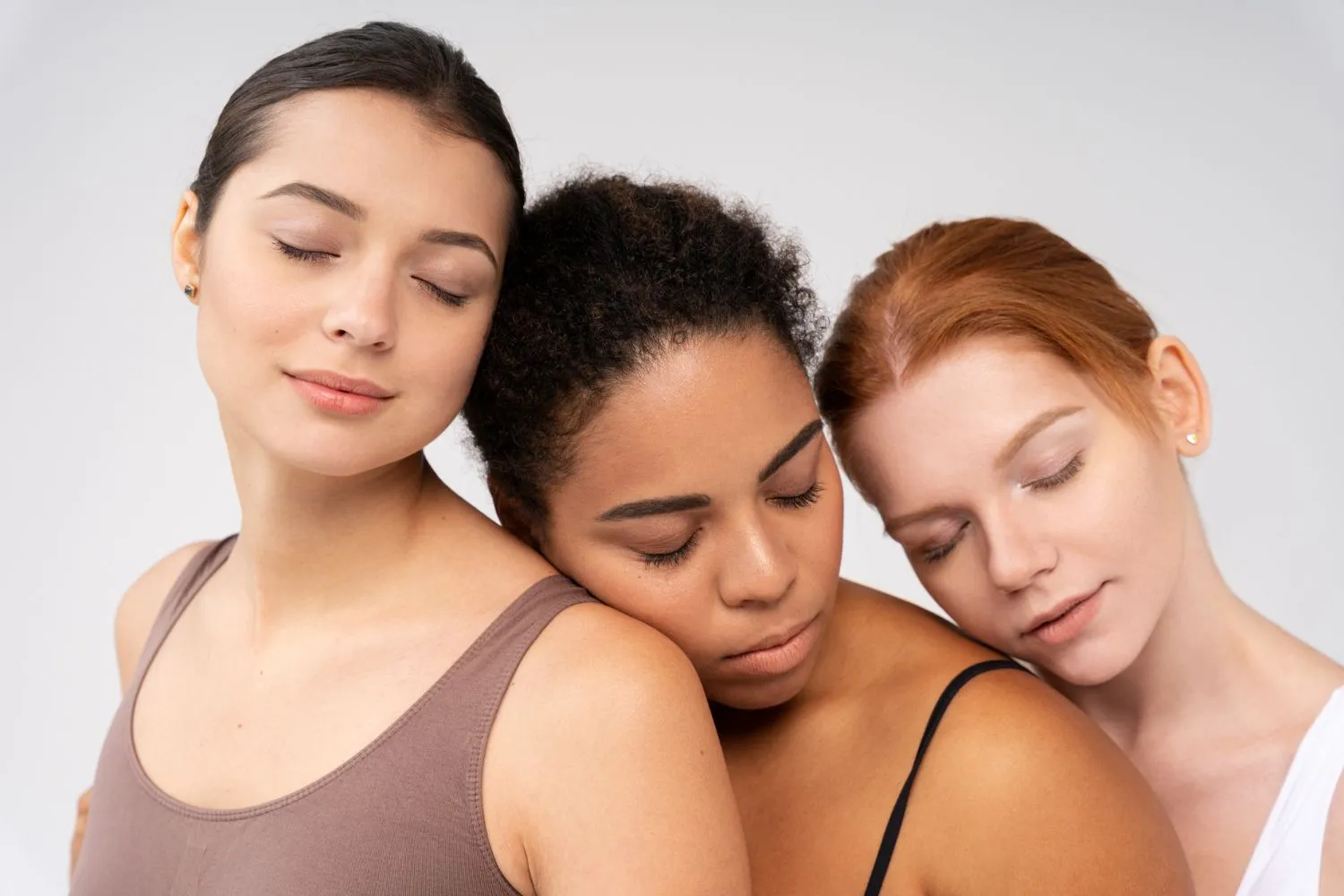 Three women of different ethnicities with closed eyes showcasing healthy skin - Allantoin in Skincare: Benefits & How to Use It 2026 - Zicail Three women of different ethnicities with closed eyes showcasing healthy skin - Allantoin in Skincare: Benefits & How to Use It 2026 - Zicail