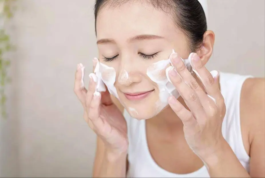 Woman cleansing her face with foam cleanser - What Are The 5 Basic Of Skin Care? 2026 - Zicail Woman cleansing her face with foam cleanser - What Are The 5 Basic Of Skin Care? 2026 - Zicail