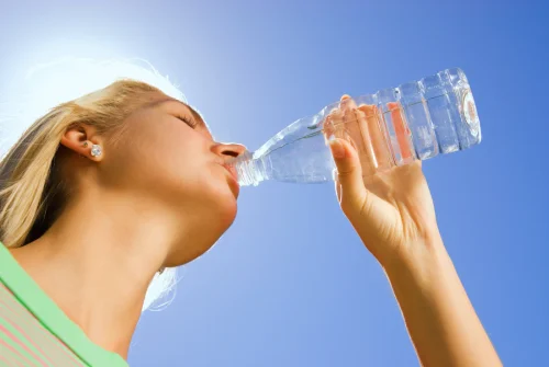 Woman drinking water outdoors under a bright sky - Natural Skincare Routine: Simple Steps for Healthy Skin [October 2026] - Zicail
