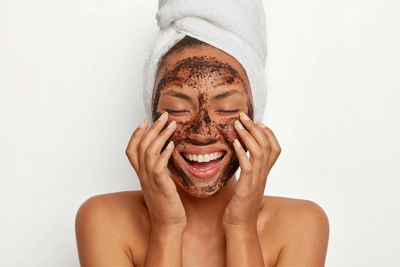 Woman smiling with a scrub exfoliating mask on her face - How to Achieve Glowing Skin: Top Tips for Radiant Skin 2026 - Zicail