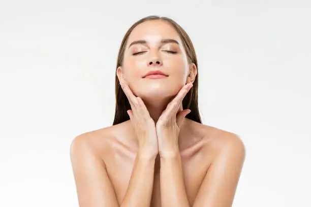 Woman touching her glowing skin with a serene expression - How to Achieve Glowing Skin: Top Tips for Radiant Skin 2026 - Zicail