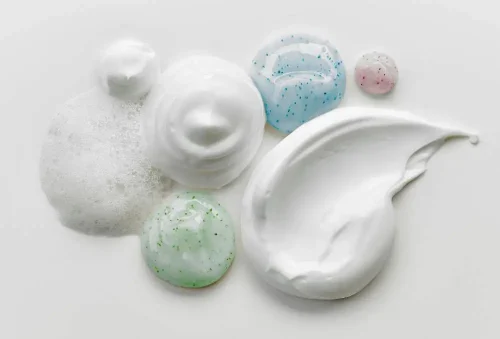 Different textures of skincare creams and gels on a white surface - How to Layer Hyaluronic Acid and Lactic Acid 2026 - Zicail