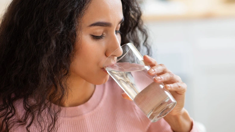 Woman drinking a glass of water for hydration - The Ultimate Lip Care Routine for Soft, Healthy Lips[October 2026] - Zicail