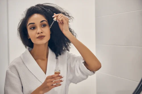 Woman applying hyaluronic acid serum to her face - How to Layer Hyaluronic Acid and Lactic Acid 2026 - Zicail