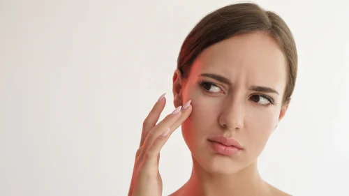 Woman examining her skin for dryness or irritation - Witch Hazel: Benefits, Uses & Side Effects for Healthy Skin 2026 - Zicail