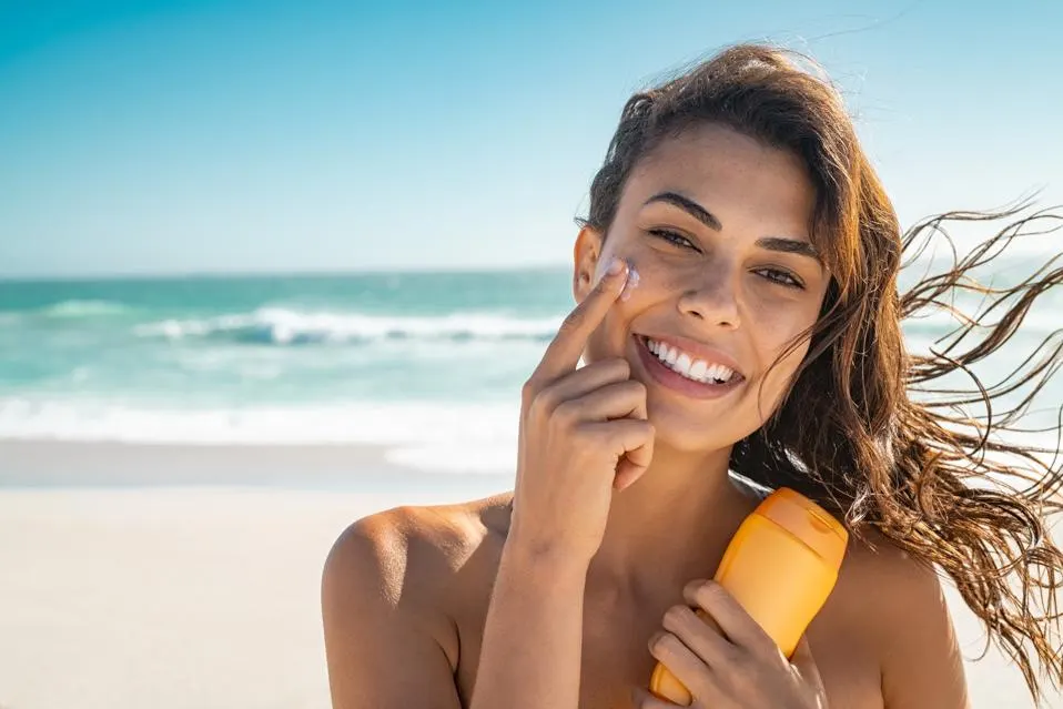 A joyful woman displays a sunscreen bottle emphasizing sun safet - Gel vs Cream Sunscreen: Choose What’s Best 2026 - Zicail A joyful woman displays a sunscreen bottle emphasizing sun safet - Gel vs Cream Sunscreen: Choose What’s Best 2026 - Zicail