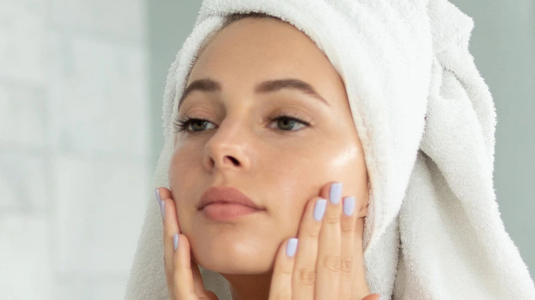 A woman with a towel on her head reflecting on Polyglutamic Acid in her skincare routine - Pyruvic Acid for Skin: Benefits, Use & Safety Guide 2026 - Zicail