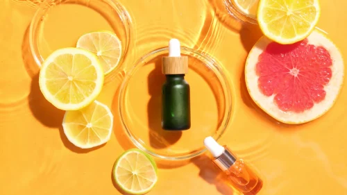 Essential oil with lemon and grapefruit slices emphasizing vitamin C - Is Vitamin C Good Under Makeup? Tips for Glowing Skin 2026 - Zicail