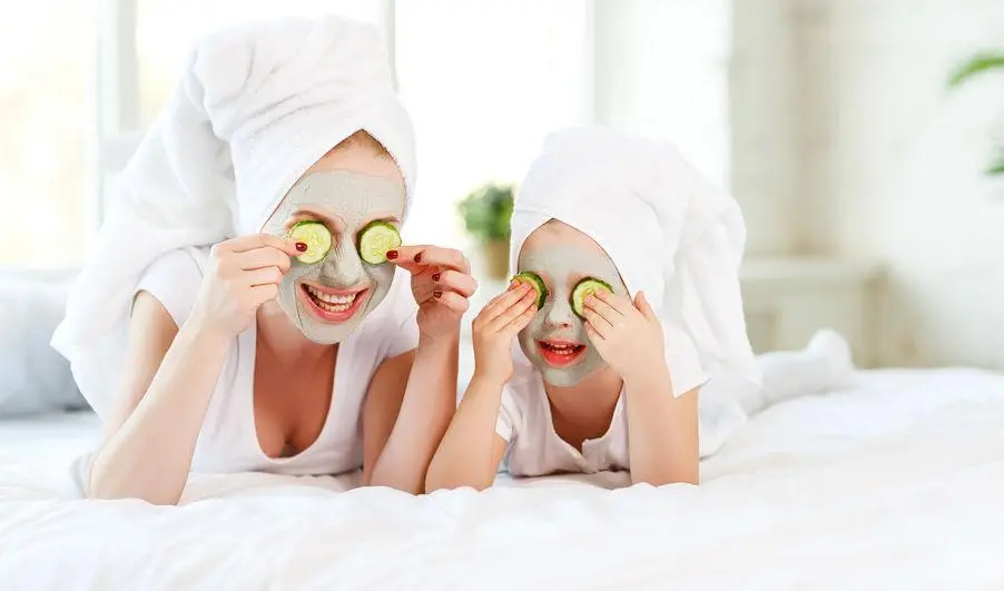 Mother and daughter applying cucumber face masks on a bed - How to Achieve Glowing Skin: Top Tips for Radiant Skin 2026 - Zicail