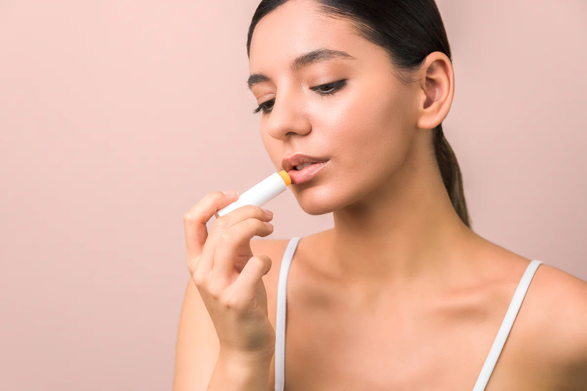 Woman doing her lip care routine by applying a lip balm - The Ultimate Lip Care Routine for Soft, Healthy Lips[October 2026] - Zicail