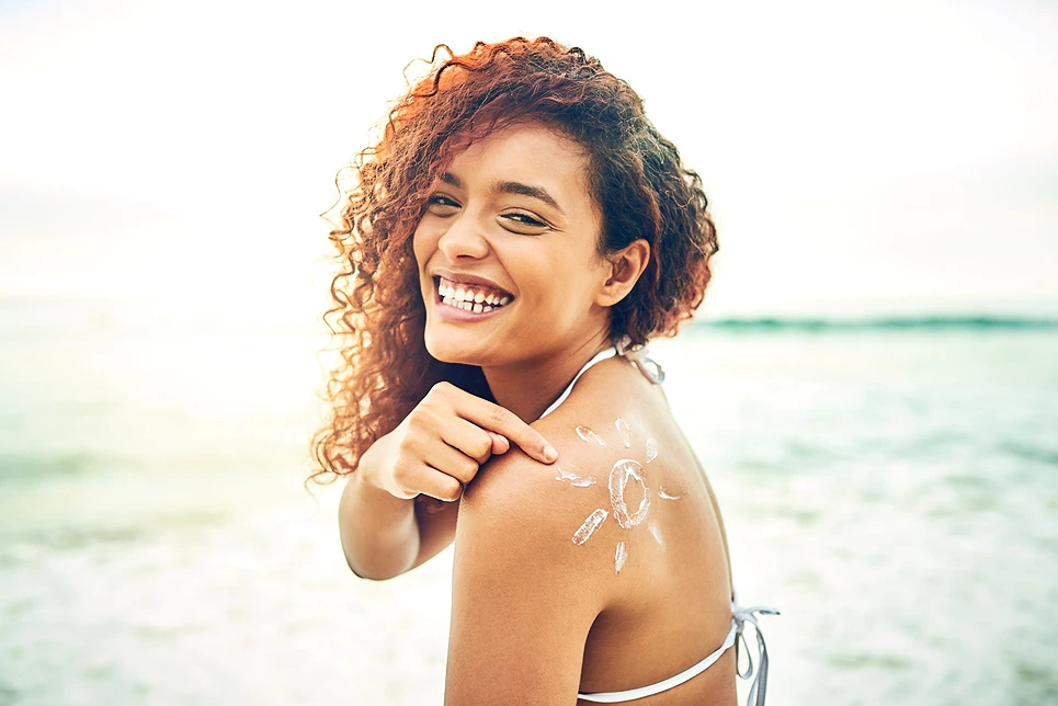 Smiling woman with sun drawn in sunscreen - What Is a Natural Sunscreen? Full Guide + Tips 2026 - Zicail Smiling woman with sun drawn in sunscreen - What Is a Natural Sunscreen? Full Guide + Tips 2026 - Zicail