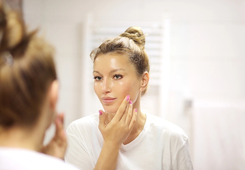 Woman checking her face for signs of skin peeling - Pyruvic Acid for Skin: Benefits, Use & Safety Guide 2026 - Zicail
