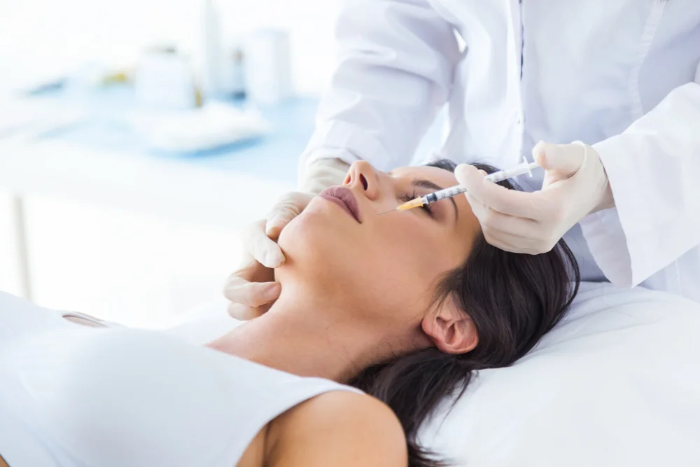 Woman receiving injection treatment for eye bags - How to Get Rid of Bags Under the Eyes 2026 - Zicail