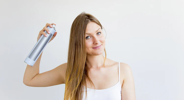 Woman spraying dry shampoo on hair to treat oily hair - How to Treat and Manage Oily Hair？ 2026 - Zicail