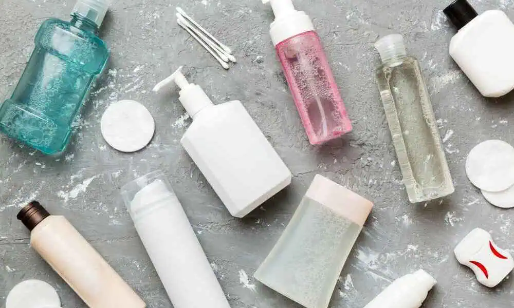 Assorted skincare bottles and cotton pads on a gray surface - Airless Bottles vs Pump Bottles: Which Fits Your Formula? 2026 - Zicail