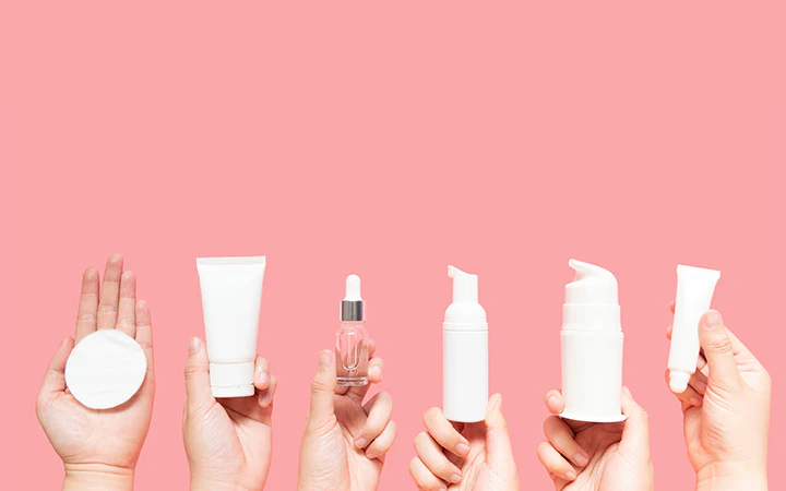 Collection of skincare bottles on a pink background - Xylitol in Skincare: Hydration, Benefits & Uses Explained 2026 - Zicail