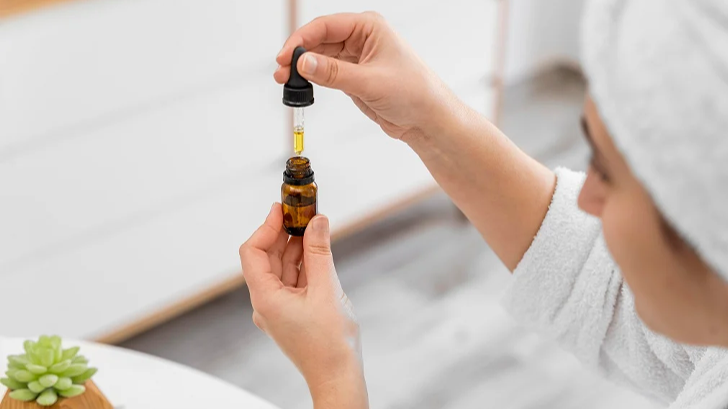 Applying a drop of fermented oil serum to the skin showcasing the moisturizing benefits of fermented oils - Fermented Oils in Skincare: Benefits & Best Practices 2026 - Zicail