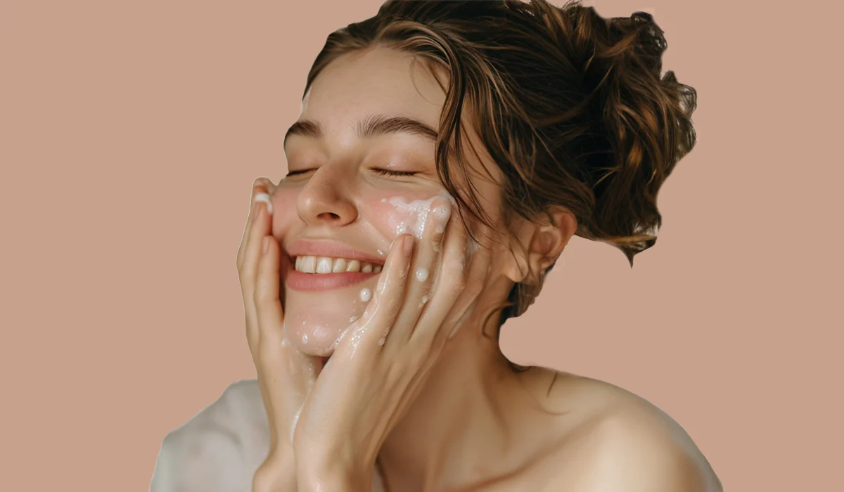 Happy woman cleansing face with goat milk for skin benefits