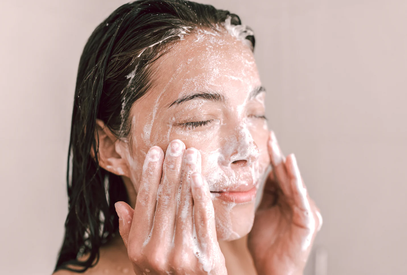 Woman gently washing face with goat milk for skin cleanser - What Is Double Cleanse & Do You Need It? 2026 - Zicail