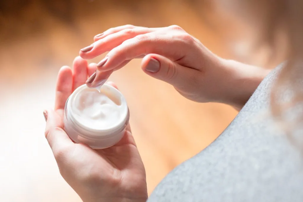 Hand applying Urea in Skincare cream from a small jar - Urea in Skincare: Benefits, Uses & Safe Guide 2026 - Zicail Hand applying Urea in Skincare cream from a small jar - Urea in Skincare: Benefits, Uses & Safe Guide 2026 - Zicail