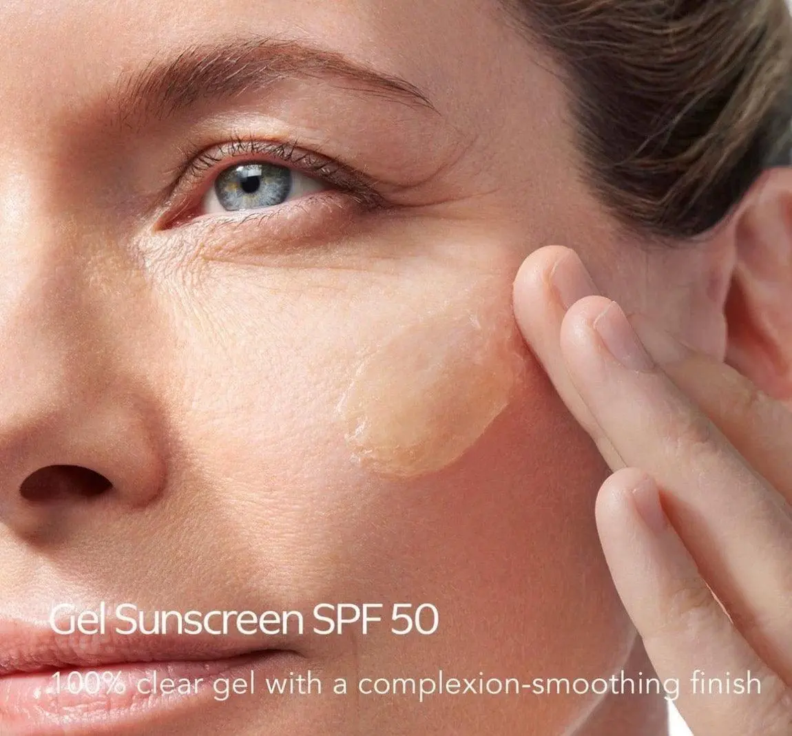Close up of woman applying SPF 50 gel sunscreen to her cheek - Gel vs Cream Sunscreen: Choose What’s Best 2026 - Zicail Close up of woman applying SPF 50 gel sunscreen to her cheek - Gel vs Cream Sunscreen: Choose What’s Best 2026 - Zicail