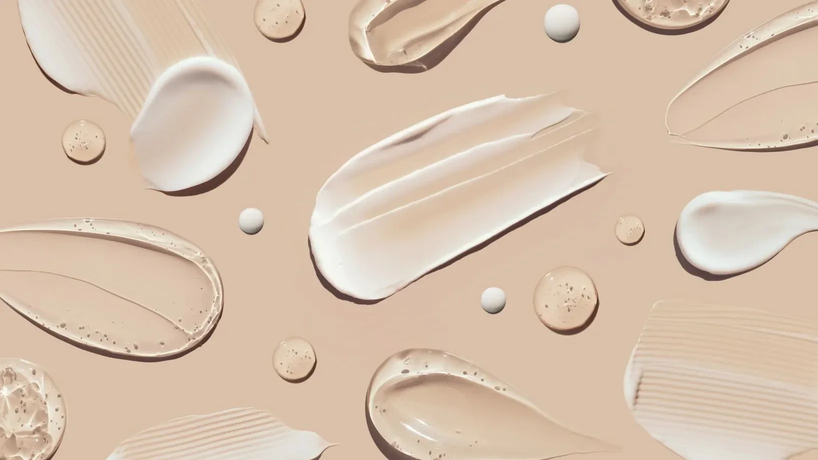 Flat lay of sunscreen gel and cream textures on nude background - Gel vs Cream Sunscreen: Choose What’s Best 2026 - Zicail Flat lay of sunscreen gel and cream textures on nude background - Gel vs Cream Sunscreen: Choose What’s Best 2026 - Zicail