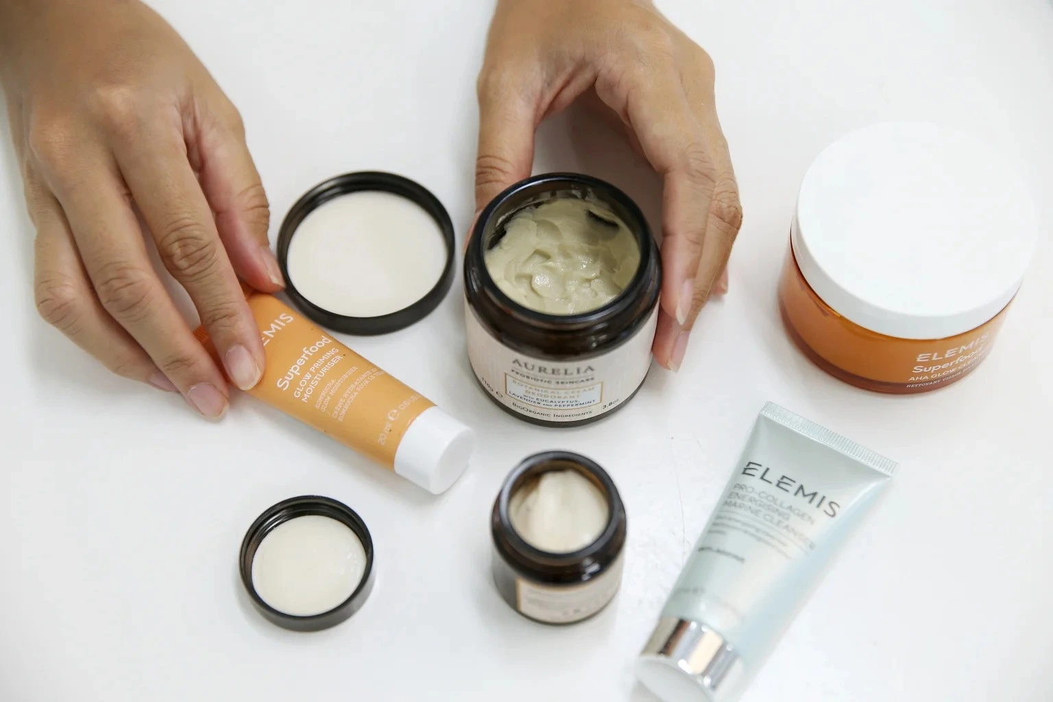 Hands holding jars and tubes of probiotics in skincare - Probiotics in Skincare: Mechanisms & Best Practices 2026 - Zicail Hands holding jars and tubes of probiotics in skincare - Probiotics in Skincare: Mechanisms & Best Practices 2026 - Zicail