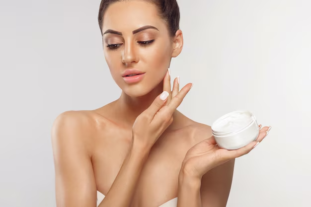 Woman applies face cream with caffeic acid in skincare - Caffeic Acid in Skincare: Benefits & How to Use 2026 - Zicail